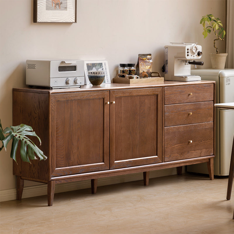 Solid oak sideboard styled against a warm plaster wall