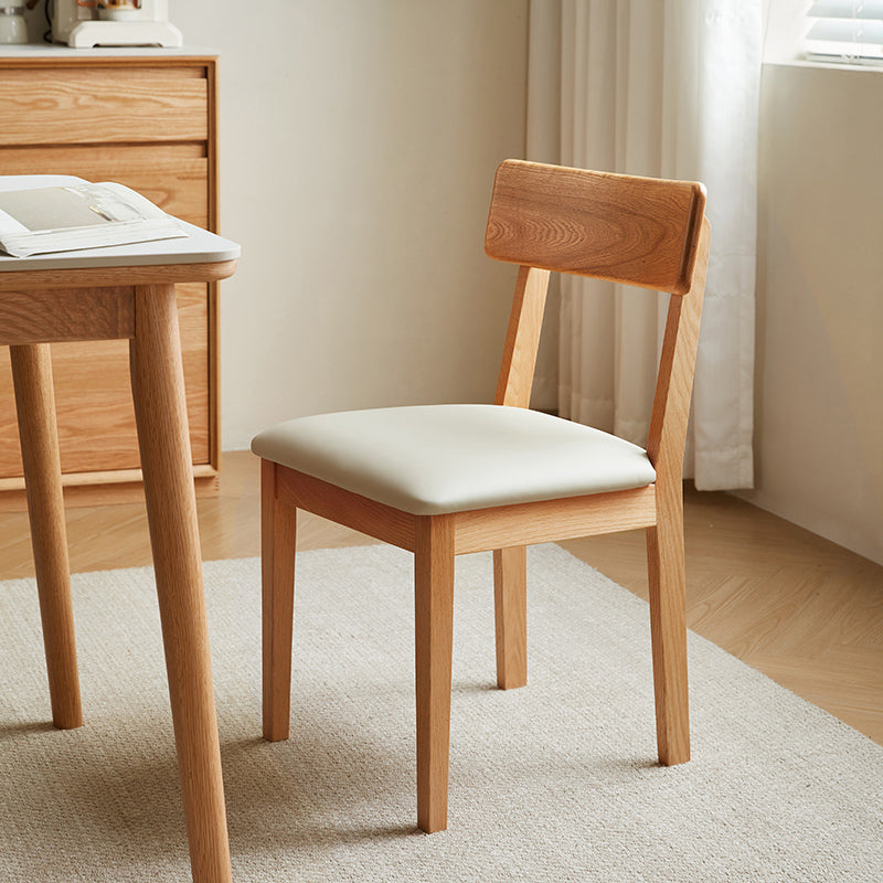 Kya armless solid oak dining chair in walnut colour