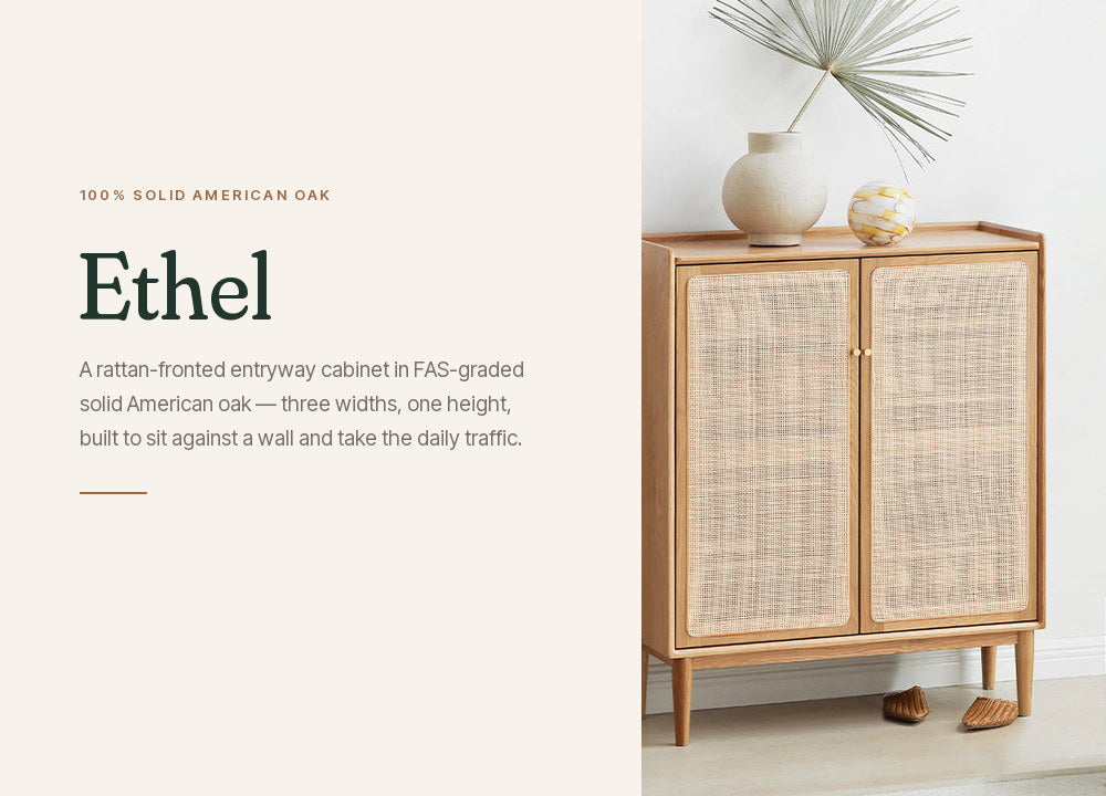 Ethel shoe cabinet in solid American oak, styled in an entryway with a vase and dried palm