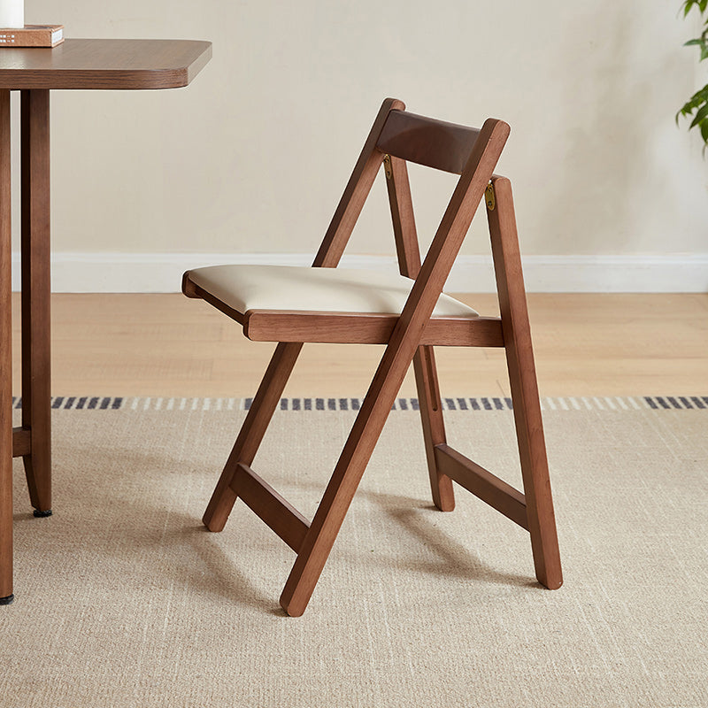 Kurt folding timber dining chair in walnut colour