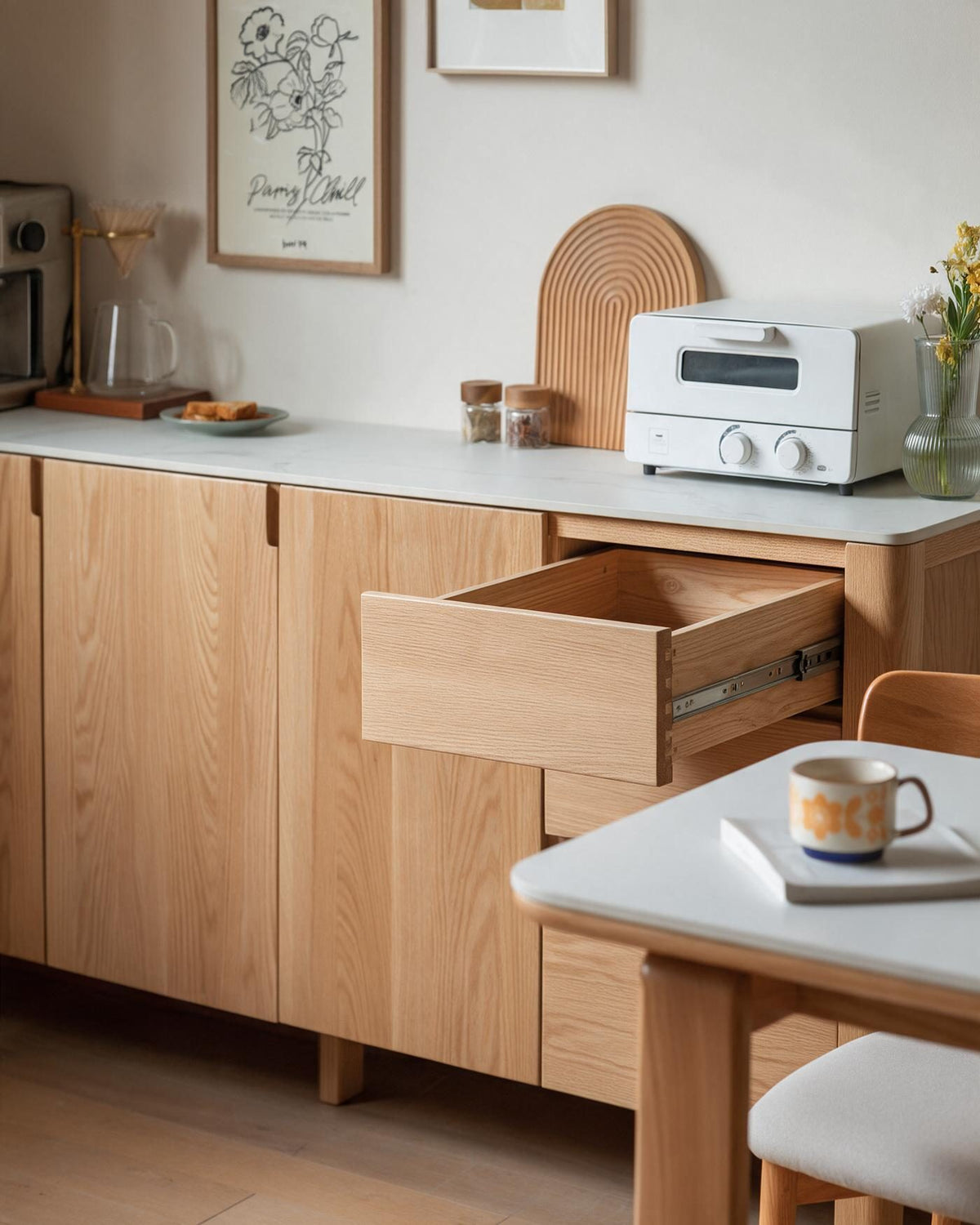 A solid timber drawer pulled open, showing dovetailed sides and a soft-close runner